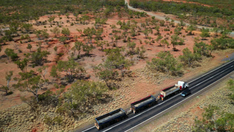 Aerial-View-Of-Three-trailer-Road-Train-With-Empty-Freight-Driving-In-Asphalt-Road-In-QLD,-Australia