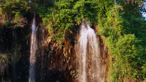 The-natural-waterfall-that-flows-down-the-mountain-is-lit-by-the-evening-sun