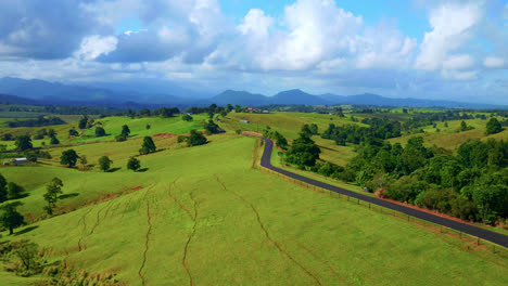 Scenic-Country-Road-Amidst-Vibrant-Greenery-Slopes-In-Atherton-Tablelands,-Queensland-Australia