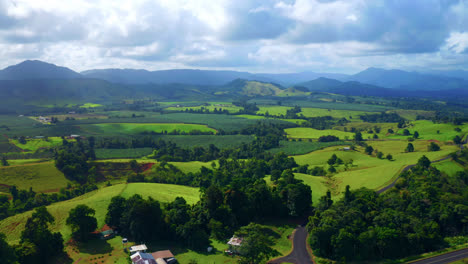 Countryside-Landscape-With-Green-Trees,-Vast-Fields-And-Country-Road-In-Atherton-Tablelands-Region,-Queensland-Australia---aerial-drone-shot