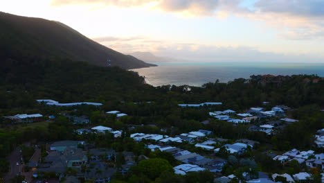 Drone-Flying-Over-Coastal-Suburb-Of-Palm-Cove-In-Queensland,-Australia-At-Sunset