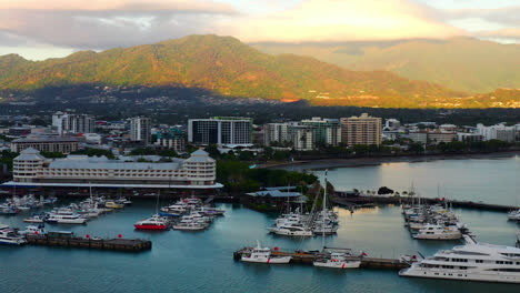 Aerial-View-of-Harbor-and-Marina-in-Cairns,-Queensland,-Australia-at-Sunrise---drone-shot