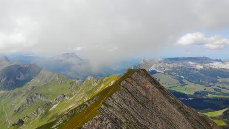 Aerial:-mountain-ridge-among-clouds-in-the-swiss-alps
