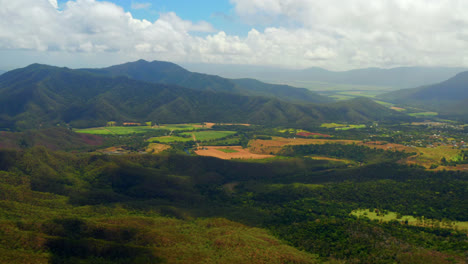 Landscape-Of-Lush-Green-Fields-And-Mountains-In-Atherton-Tablelands,-Queensland,-Australia---aerial-drone-shot
