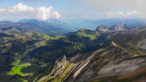 Aerial:-mountain-ridge-and-valleys-among-clouds-in-the-swiss-alps