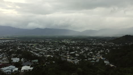 Panning-shot-of-Cains-City-in-the-North-of-Queensland,Australia-during-cloudy-day-with-mountains-in-backdrop