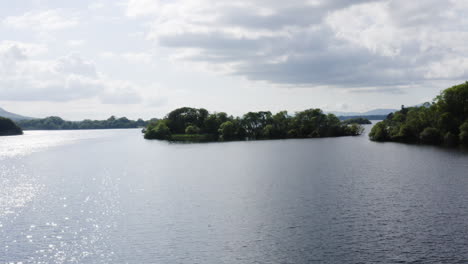 AERIAL---Muckross-Lake-in-Killarney-National-Park,-Ireland,-wide-shot-truck-right