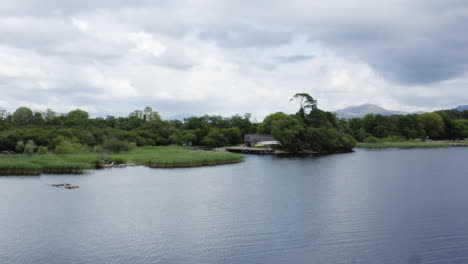 AERIAL---Wetlands-and-forest-in-Killarney-National-Park,-Ireland,-forward-cinematic