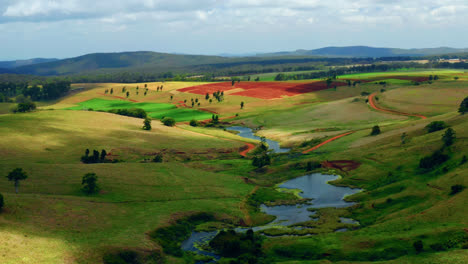 Landscape-Of-Colorful-Fields-And-Creeks-In-Atherton-Tablelands-Region,-Queensland,-Australia---aerial-drone-shot