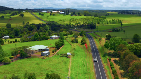 Car-Driving-In-The-Asphalt-Road-At-Atherton-Town-At-Summer-In-Tablelands,-QLD,-Australia
