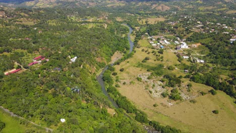 Río-Yaque-del-Norte-aerial-view-stunning-environment-with-wildlife,-nature-and-a-small-village