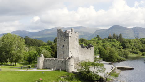 AERIAL---Ross-Castle-in-Killarney-National-Park,-Ireland,-rising-circle-pan