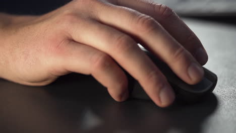 Slow-motion-close-up-of-a-male-hand-using-a-wireless-computer-mouse