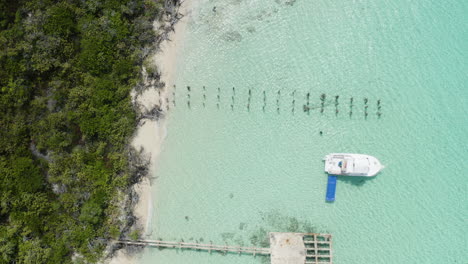 AERIAL---Boat-on-clear-turquoise-waters,-Cayo-Icacos,-Puerto-Rico,-top-down-lowering