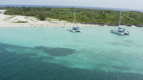 AERIAL---People,-catamaran-boats,-clear-water,-Cayo-Icacos,-Puerto-Rico,-rising-reverse