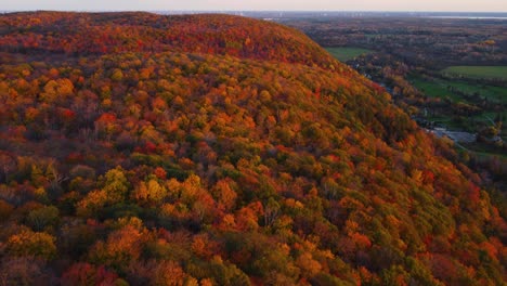 Aerial-view-of-Gatineau-park-at-sunset-in-autumn-panning-towards-the-city-of-Ottawa