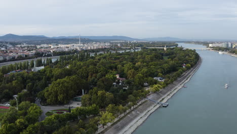 AERIAL---Margaret-Island-on-the-Danube,-Budapest,-Hungary,-landscape-shot-lowering