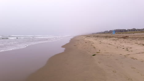 Pajaro-Dunes-Beach-in-central-California-on-a-foggy,-misty-day---low-altitude-flyover