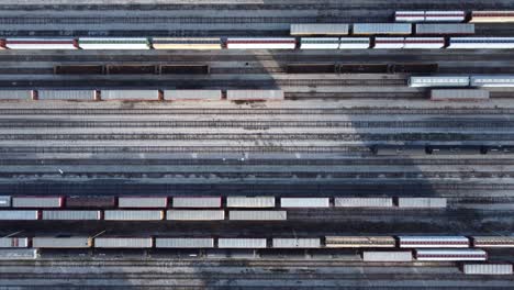 drone-shot-of-railways,-Flying-above-industrial-railroad-station-with-cargo-trains-and-freight-containers