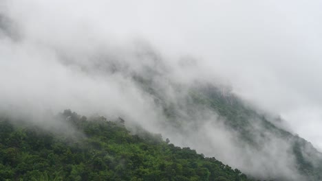 Fog-seen-moving-up-at-a-mountain-rainforest-during-a-rainy-day-in-Sai-Yok,-Kanchanaburi,-Thailand