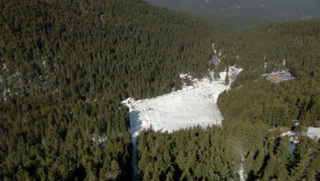 Drone-shot-of-snowy-peak-and-ski-slope-in-Malyovitsa-in-Bulgaria