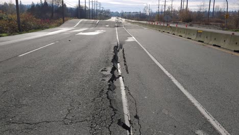 Cracked-asphalt-on-Highway-11-after-historical-flooding-in-Canada,-dolly-forward-shot