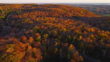 Aerial-panning-view-of-the-hills-of-Gatineau-Park-and-the-Ottawa-Valley-at-sunset-in-autumn