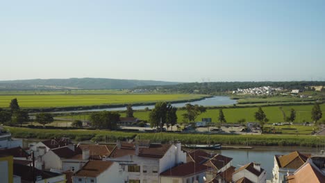 Portugal-green-field-with-river-crossing-and-foreground-houses