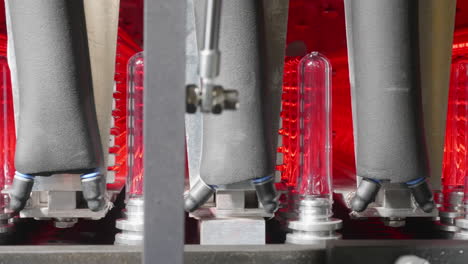 A-closeup-shot-of-how-plastic-PET-preforms-are-being-put-into-a-heating-machine