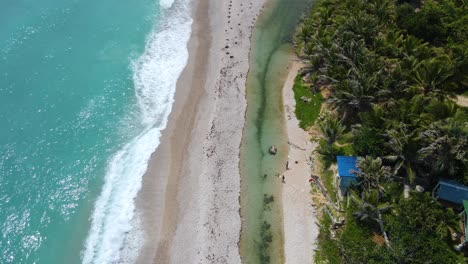 Los-Patos,-shortest-river-in-the-Caribbean,-aerial-view-during-a-windy-day-with-the-strong-waves-next-to-the-river