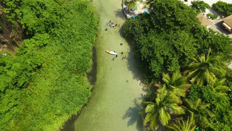 Los-Patos,-Dominican-Republic-one-of-the-shortest-rivers-in-the-world-aerial-view-in-a-sunny-day-with-the-beach-at-the-background