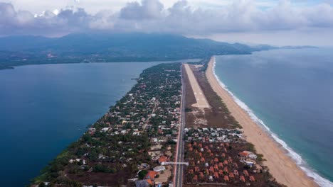 Aerial-hyper-lapse-Pie-de-la-Cuesta-peninsula,-sand-beach-and-emerald-sea,-Acapulco-Guerrero