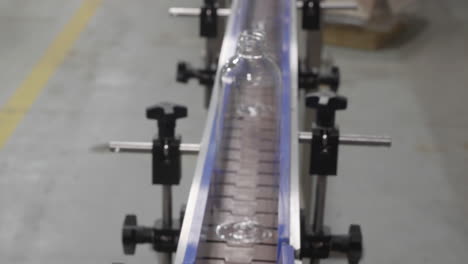 Plastic-bottles-are-being-transported-on-a-conveyor-belt-to-a-packaging-stage