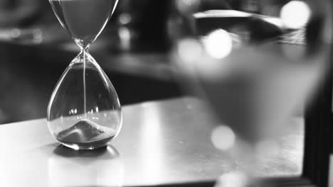 Sand-running-through-the-bulbs-of-an-hourglass-measuring-the-passing-time-in-a-countdown-to-a-deadline