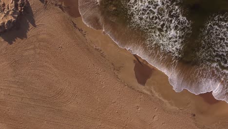 Isolated-and-unrecognizable-person-walking-on-beach-at-sunrise,-Punta-del-Este-in-Uruguay