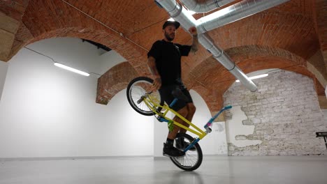 adult-male-BMX-rider-doing-hard-tricks-on-a-bike-and-falling