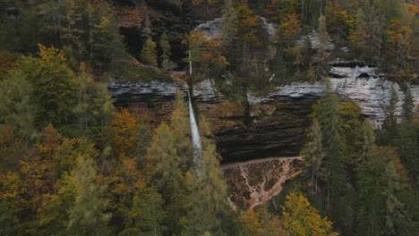 Cinematic-aerial-shot-of-majestic-Pericnik-waterfall-in-mountainside-woodland