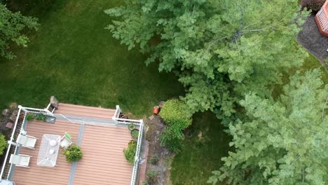 Aerial-view-house-home-backyard-with-chair,-table-and-garden