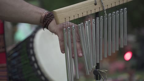 Slow-motion-close-up-View-of-man-hand-playing-bar-chimes-during-a-religious-outdoor-event-in-Latin-America
