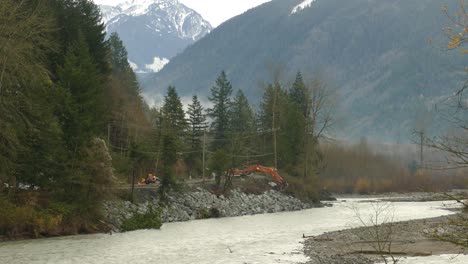 Excavator-At-Work-Clearing-Landslide-Debris-On-The-Road-After-Extreme-Rainstorm-In-British-Columbia,-Canada