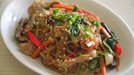 japchae-or-stir-fried-Korean-vermicelli-noodles-with-vegetables-and-pork-topped-with-white-sesame---Korean-traditional-food-style