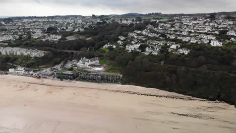 Aerial-backwards-shot-of-Carbis-Bay-town-and-Beach