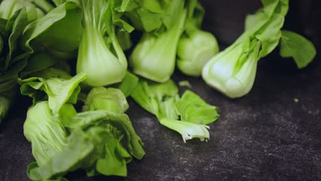 Panning-over-a-selection-of-fresh-baby-bok-choi-in-asian-kitchen
