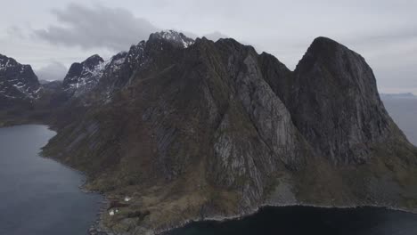 Aerial-view-of-rocky-mountains-cloudy-Lofoten,-Norway---pull-back,-drone-shot