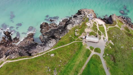 Aerial-above-shot-of-turquoise-waters-and-headland-rocks-at-St-Ives-Cornwall-England