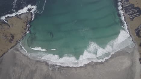 Aerial-view-above-waves-crashing-a-beach,-in-Lofoten,-Norway---birds-eye,-drone-shot