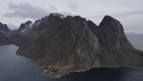 Aerial-view-around-a-massive-mountain-range,-in-cloudy-Lofoten,-Norway---orbit,-drone-shot