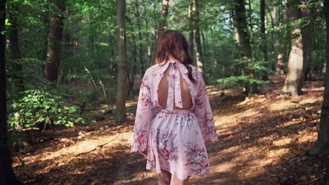 Brunette-Girl-In-Floral-Dress-Walking-On-Idyllic-Forest-At-Summertime