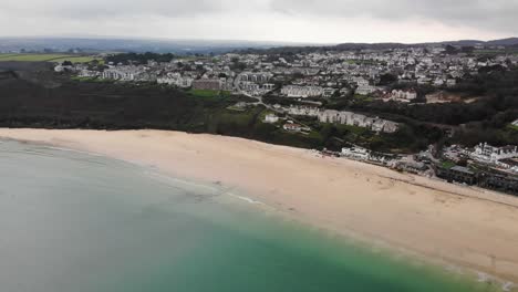 Aerial-panning-left-shot-of-the-beach-at-Carbis-Bay-Cornwall-England