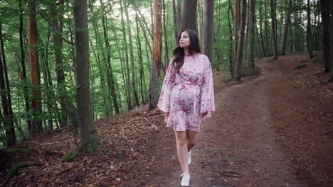 Attractive-Young-Woman-Wearing-Floral-Dress-Walking-Alone-In-Forest